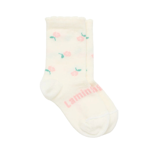 Cream-colored merino wool baby sock with floral patterns and 'lamington' branding on a white background