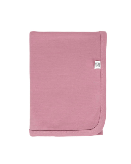 Pink baby blanket with a brand logo on a white background