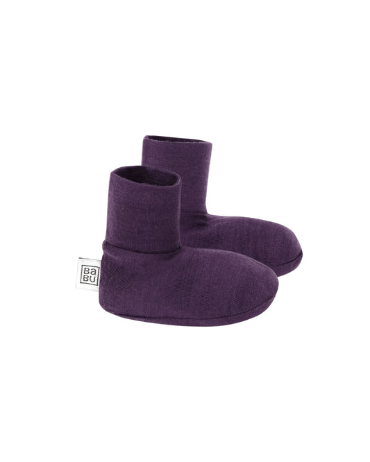 Pair of purple 100% merino wool baby socks on a light gray background
