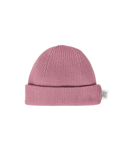 Pink merino wool knit beanie on a light gray background