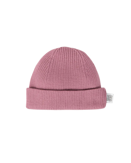 Pink merino wool knit beanie on a light gray background