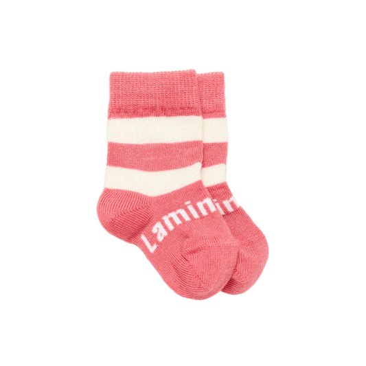 Pink merino wool baby socks with white stripes on a light gray background