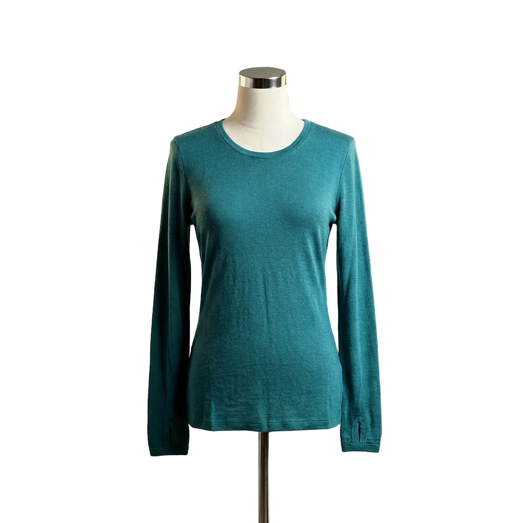 Teal merino wool long-sleeve shirt on a mannequin against a neutral background