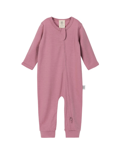 Pink 100% merino wool baby long-sleeve, footless onesie with 2-way zip on a light gray background