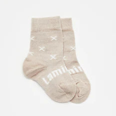 Oatmeal merino wool baby socks with white crosses and Lamington knitted across the top of the foot